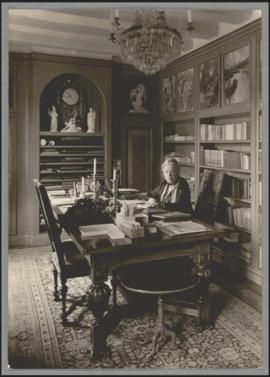 Selma Lagerlöf vid skrivbordet i arbetsrummet på Mårbacka, iklädd mörk kofta